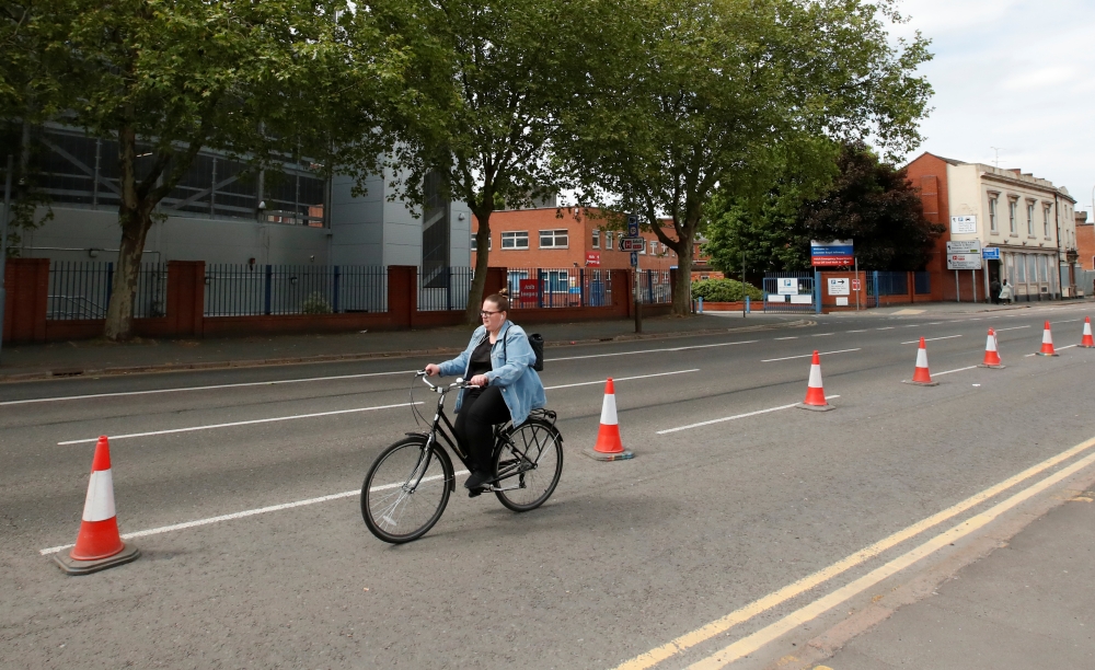 A cyclist is seen using a temporary cycling lane in Leicester, following the outbreak of the coronavirus disease (COVID-19), Leicester, Britain, May 17, 2020. REUTERS/Andrew Boyers
 