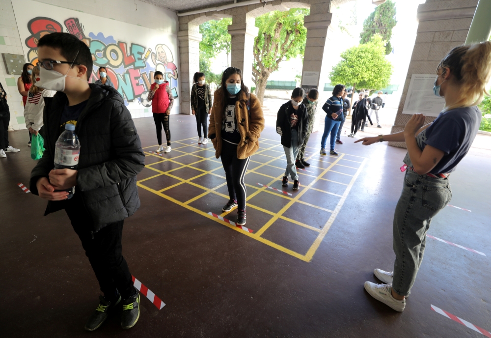 FILE PHOTO: Schoolchildren line up as they enter the primary school Simone Veil during its reopening in Nice as a small part of French children head back to their schools with new rules and social distancing during the outbreak of the coronavirus disease 