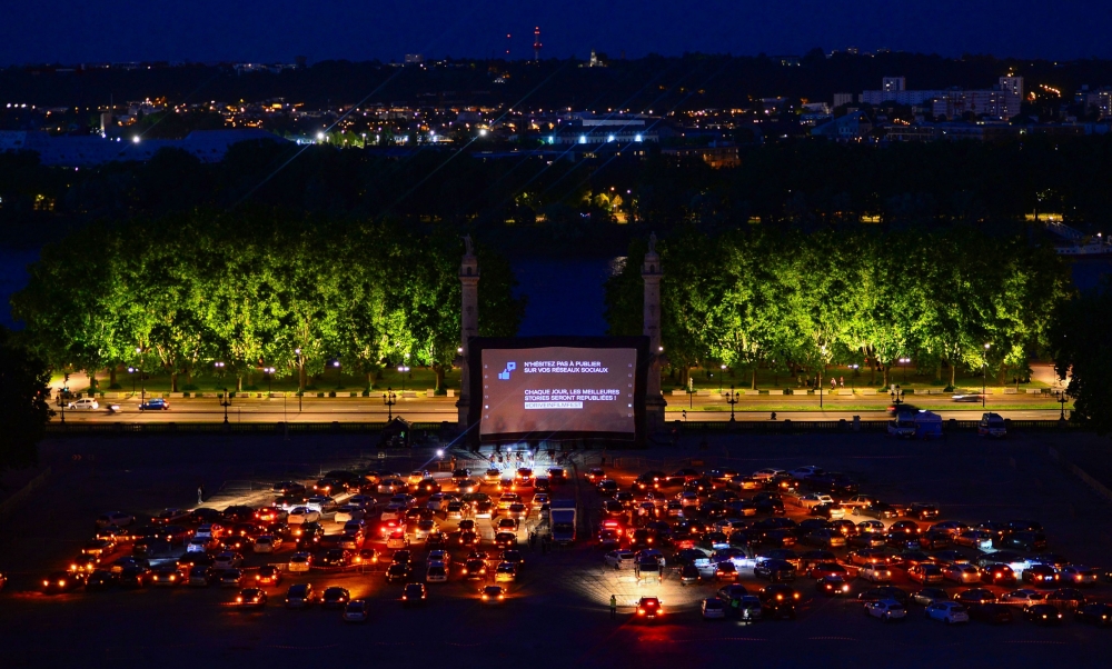  Spectators in their vehicle attend a drive-in movie screening of Hippocrates by French director Thomas Lilti, on Place des Quinconces in Bordeaux, on May 16, 2020 as part of the Drive-in Festival featuring 10 movies in 10 days, while the cinemas in Franc