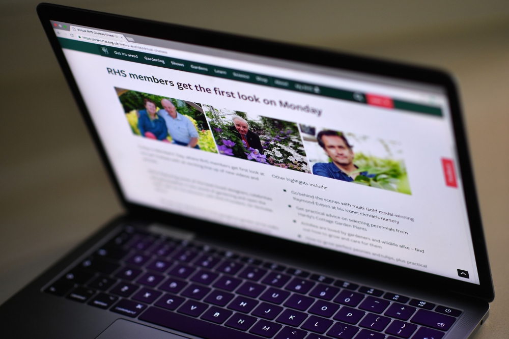 The website of the Virtual RHA Chelsea Flower Show is seen displayed on a laptop computer, in Brenchley, south east England on May 18, 2020, after the pandemic forced the cancellation of the show, the gardening showpiece event has been taken on-line. AFP 