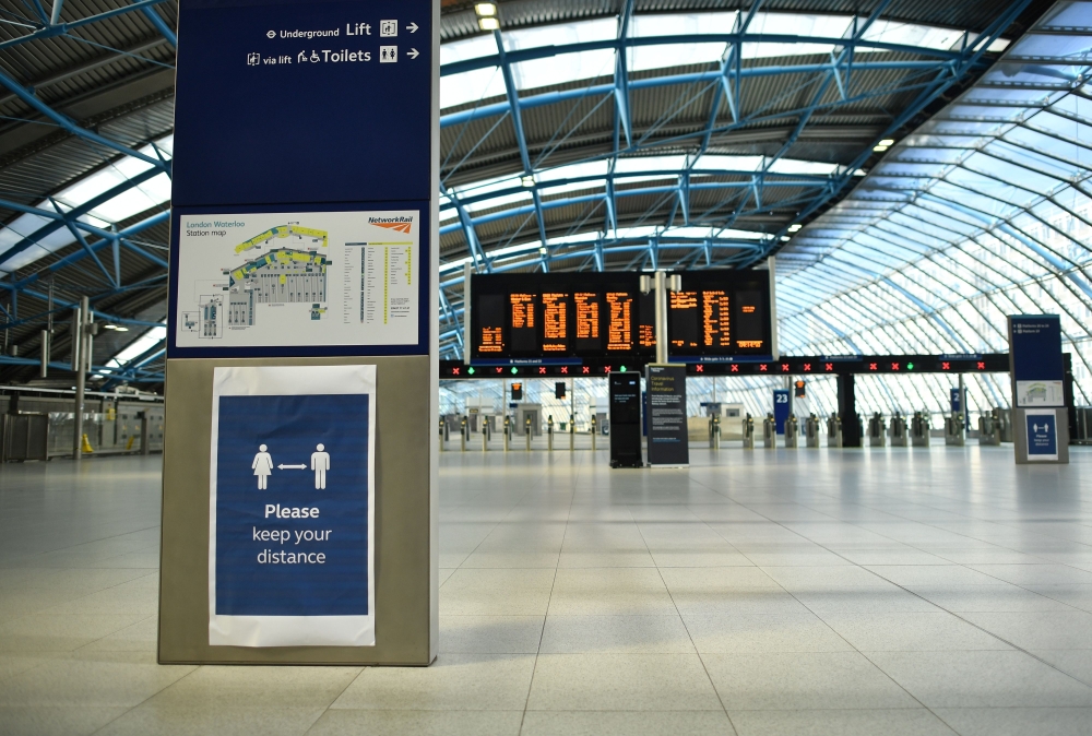 :A sign on the concourse advises passengers to adhere to social distancing at Waterloo Train station in central London on May 18, 2020. AFP / Ben STANSALL
