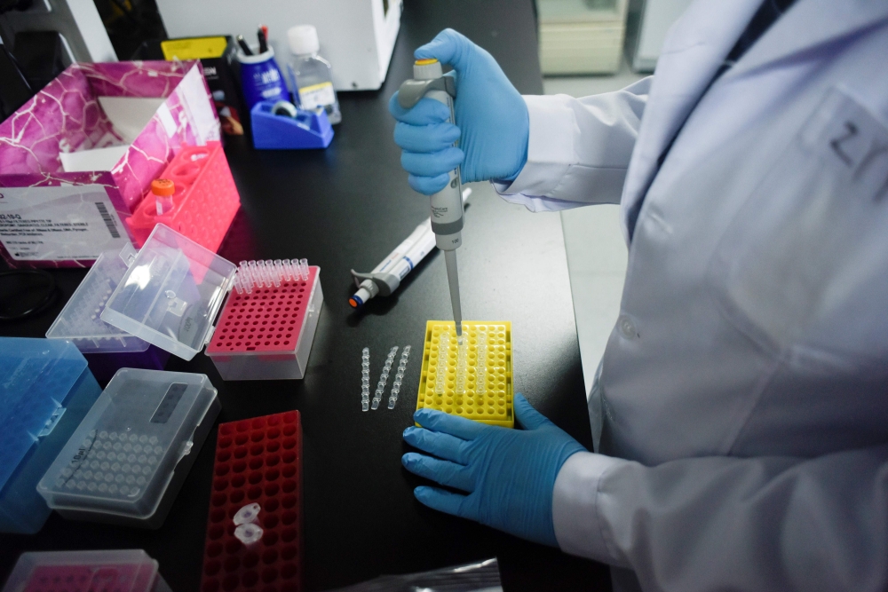 This picture taken on May 14, 2020 shows a researcher at Peking University's Beijing Advanced Innovation Center for Genomics conducting tests at their laboratory in Beijing. The Chinese laboratory says it has developed a drug it believes has the power to 