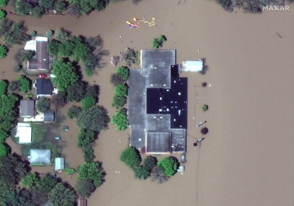 A satellite image shows a flooded Windover High School after rising floodwaters unleashed by two dam failures submerged parts of Midland, Michigan, U.S. May 20, 2020. Satellite image ?2020 Maxar Technologies/Handout via REUTERS 
