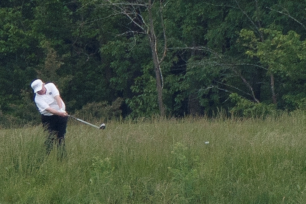 US President Donald Trump swings a golf club during a round of golf in Sterling, Virginia, US on May 24, 2020. (REUTERS/Tom Brenner)