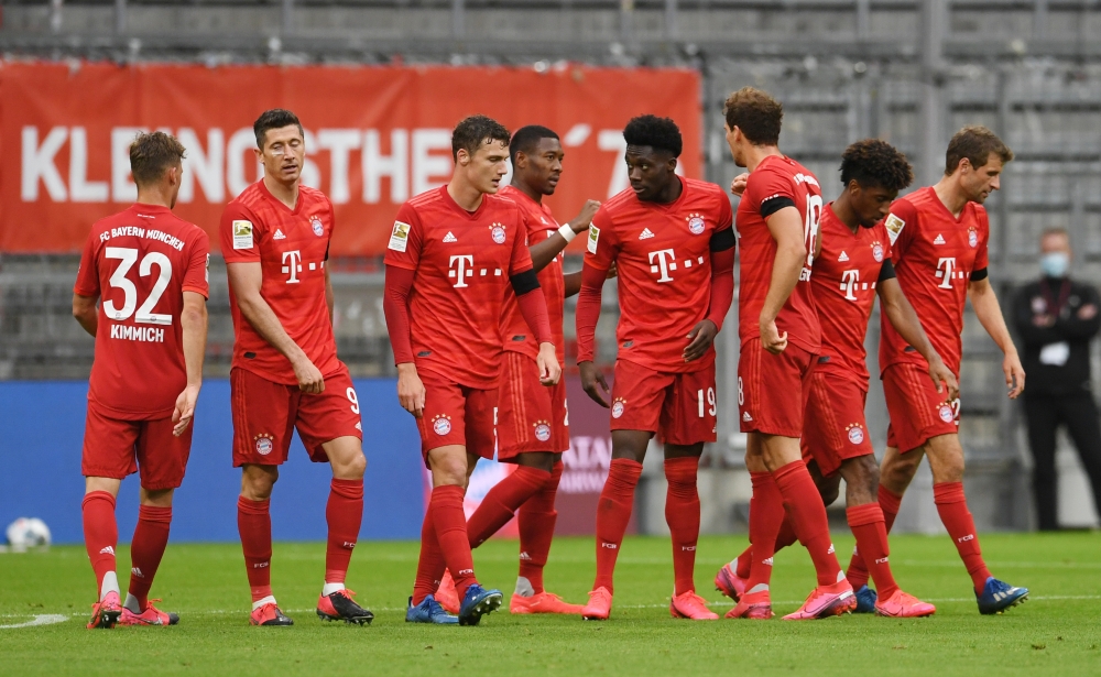 Bayern Munich's Alphonso Davies celebrates scoring their fourth goal with teammates, as play resumes behind closed doors following the outbreak of the coronavirus disease (COVID-19) REUTERS/Andreas Gebert/