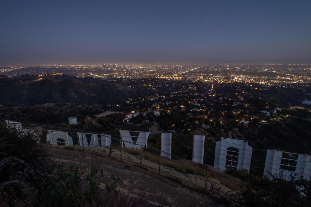 TOPSHOT - The Hollywood sign is pictured from the back at dusk during the second day of the Memorial Day holiday weekend, during the novel Coronavirus, COVID-19, pandemic in Los Angeles, California on May 24, 2020. / AFP / Apu GOMES
