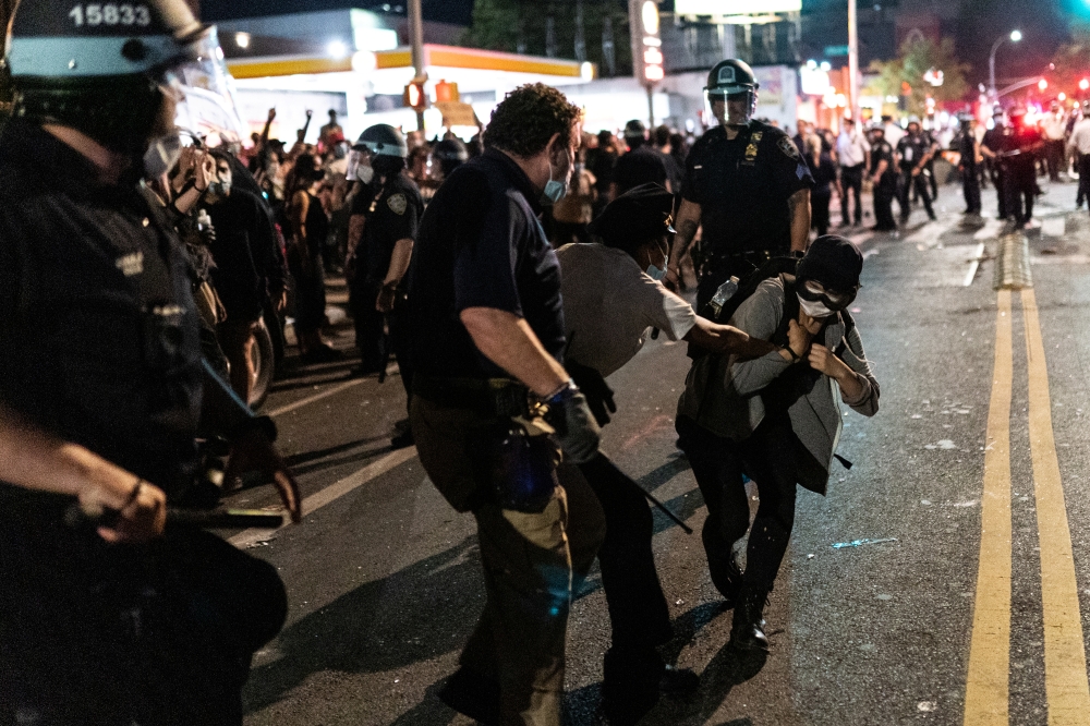 NYPD police officers detain a protester as they clash during a march against the death in Minneapolis police custody of George Floyd, in the Brooklyn borough of New York City, U.S., May 30, 2020. Picture taken May 30, 2020. REUTERS/Jeenah Moon