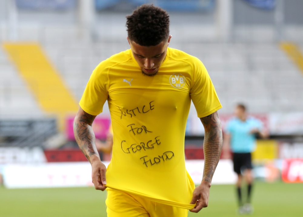 Borussia Dortmund's Jadon Sancho celebrates scoring their second goal with a 'Justice for George Floyd' shirt, as play resumes behind closed doors following the outbreak of COVID-19
