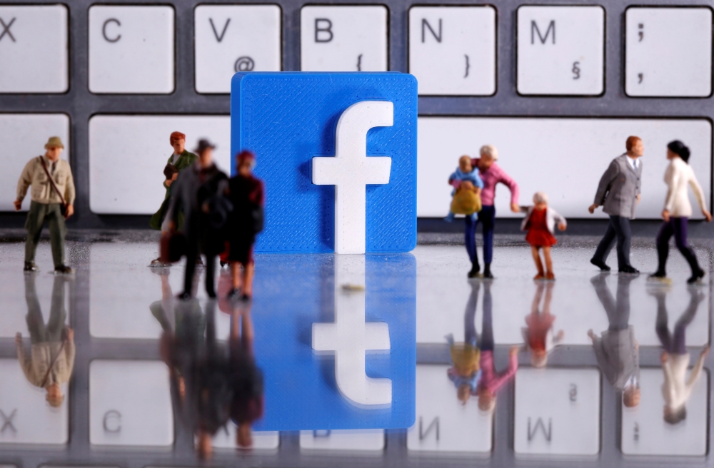 FILE PHOTO: A 3D printed Facebook logo is placed between small toy people figures in front of a keyboard in this illustration taken April 12, 2020. REUTERS/Dado Ruvic/Illustration
