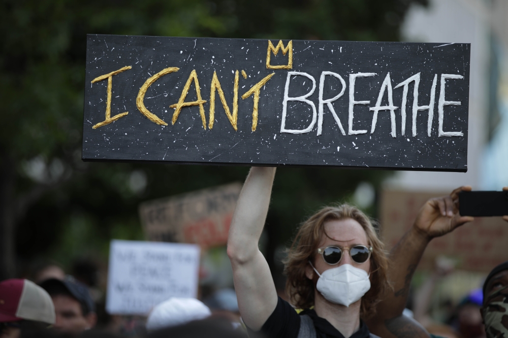 WASHINGTON, USA - JUNE 2: A person holds a banner during a protest over the death of George Floyd, an unarmed black man who died after being pinned down by a white police officer in Minneapolis, United States on June 2, 2020 in Washington, United States. 