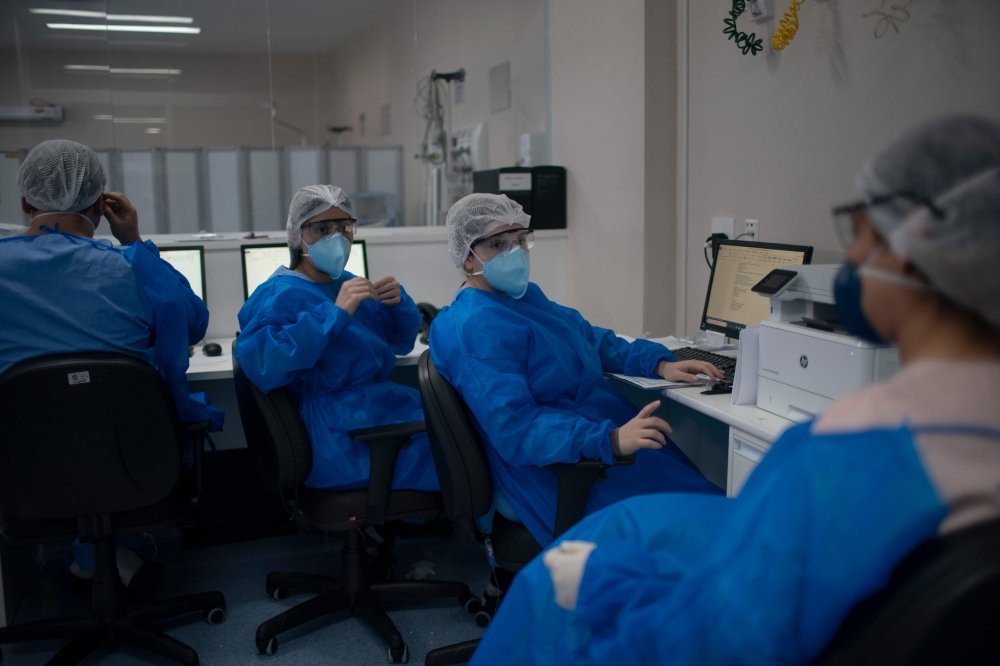 Health professionals work at the Intensive Care Unit (ICU) ward where patients infected with the novel coronavirus, COVID-19, are being treated at the Doctor Ernesto Che Guevara Public Hospital in Marica city, state of Rio de Janeiro, Brazil, on June 5, 2