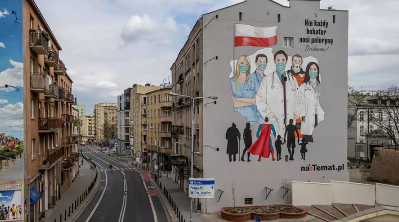 FILE PHOTO: A mural showing medical personel wearing protective masks is seen painted on a wall of a building following the coronavirus disease (COVID-19) outbreak in Warsaw, Poland, April 1, 2020. Slawomir Kaminski/Agencja Gazeta via REUTERS
