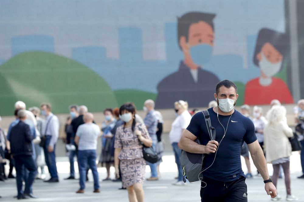 People wearing masks as a precaution against coronavirus (Covid-19) wait in a queue as lockdown was lifted in Moscow, Russia on June 9, 2020. ( Sefa Karacan - Anadolu Agency )