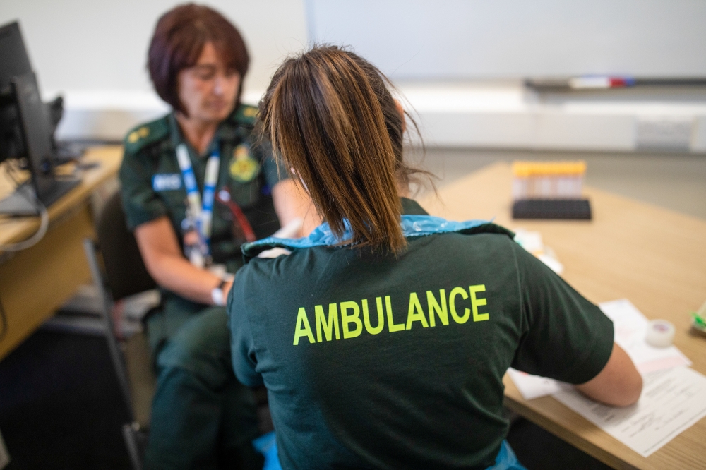 A paramedic takes a blood sample from a medical worker, during an antibody testing program at the Hollymoor Ambulance Hub of the West Midlands Ambulance Service, operated by the West Midlands Ambulance Service NHS Foundation Trust, in Birmingham, Britain 