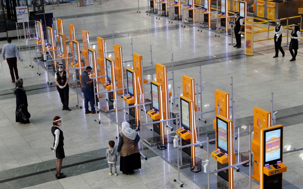 Pegasus Airlines self check-in counters are seen at the nearly empty domestic departure terminal of the Sabiha Gokcen Airport, following the coronavirus disease (COVID-19) outbreak, in Istanbul, Turkey June 11, 2020. REUTERS/Murad Sezer