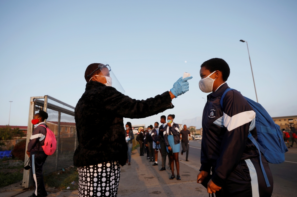 A learner is screened as schools begin to reopen after the coronavirus disease (COVID-19) lockdown in Langa township in Cape Town, South Africa June 8, 2020. REUTERS/Mike Hutchings/File Photo
 