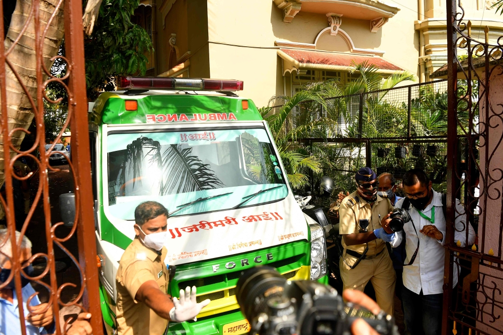 An ambulance carrying the body of Indian Bollywood actor Sushant Singh Rajput is seen leaving after he took his own life, at his residence in Mumbai on June 14, 2020. AFP / INDRANIL MUKHERJEE
