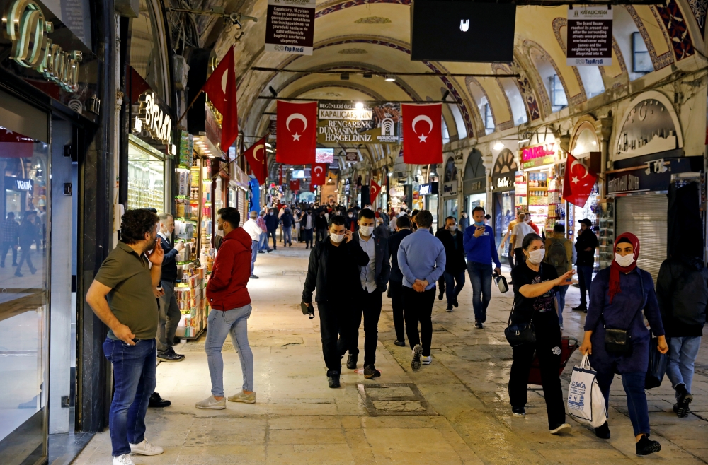 FILE PHOTO: People wearing protective face masks walk at Grand Bazaar as it reopens after weeks of the close doors amid the spread of the coronavirus disease (COVID-19), in Istanbul, Turkey, June 1, 2020. REUTERS/Umit Bektas/File Photo
