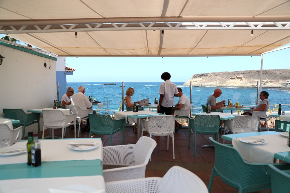 FILE PHOTO: Waiter Yamilca from Cuba attends tourists in a terrace of an almost empty restaurant 