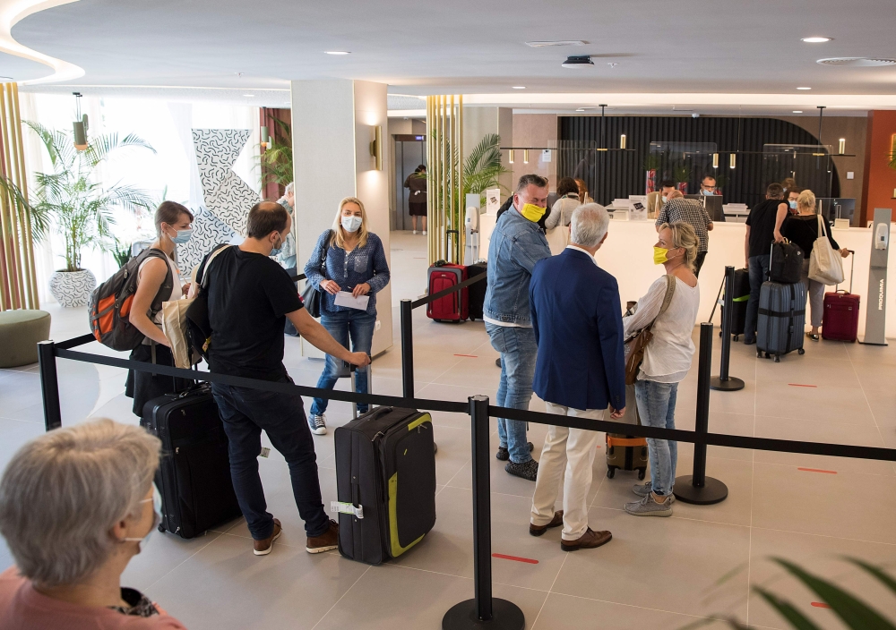 German tourists arrive at the RIU Concordia hotel in Palma de Mallorca on June 15, 2020, as part of a pilot program to reactivate tourism a week before Spain reopens its borders. Spain, one of the world's leading tourist destinations, will next June 21 re