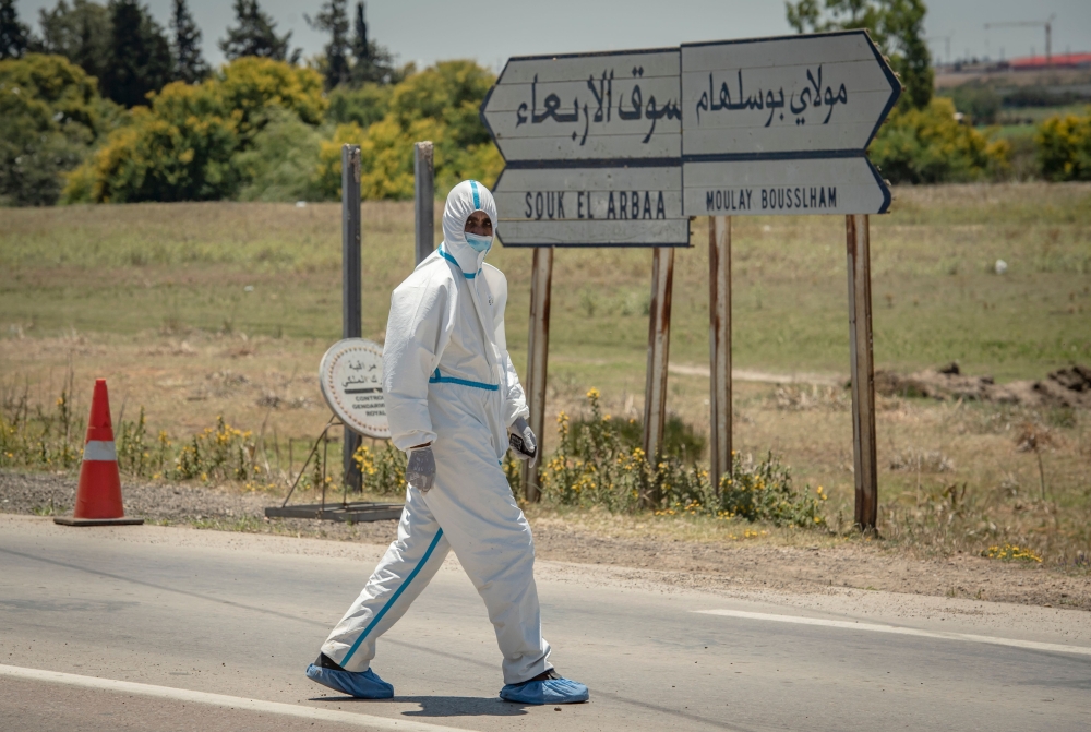 A member of the medical staff walks around during his break in the town of Moulay Bousselham, north of the capital Rabat, on June 20, 2020, as authorities received around 700 COVID-19 patients. / AFP / FADEL SENNA