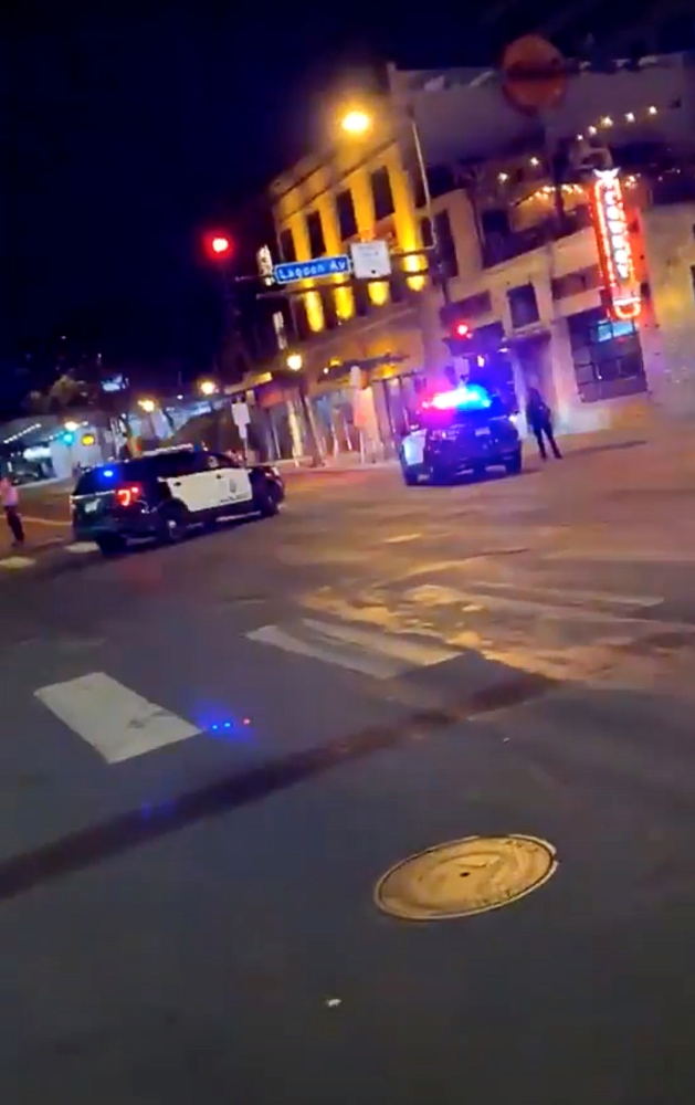 Police vehicles block the road after a shooting in Minneapolis, Minnesota, U.S. June 21, 2020, in this picture obtained from social media video. TWITTER @MRMINNESOTA24 /via REUTERS 