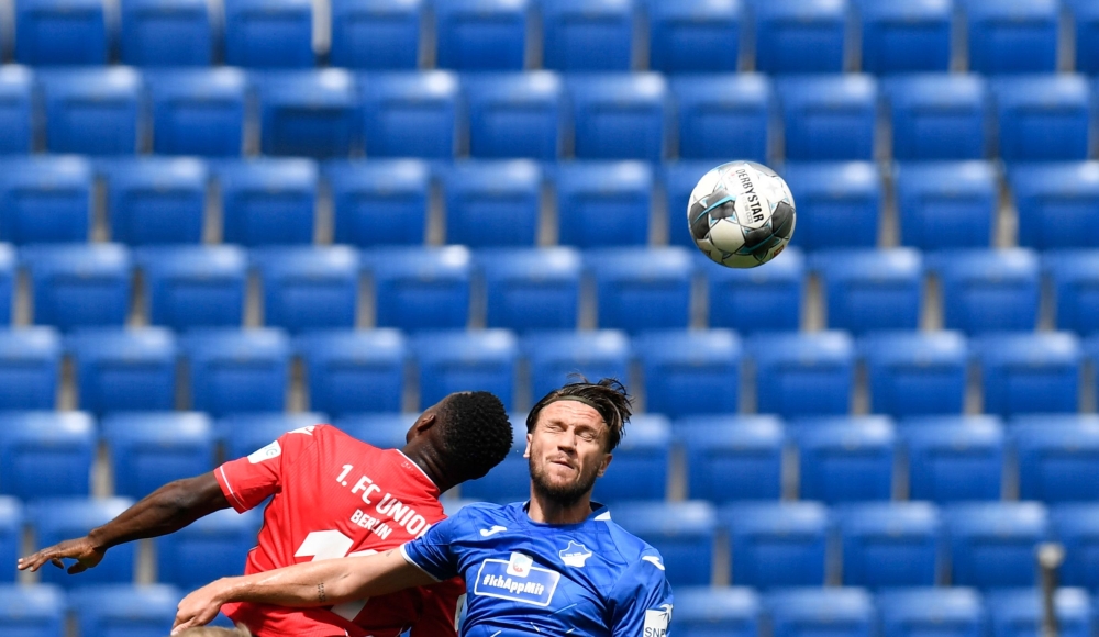 Union Berlin's Nigerian forward Anthony Ujah (L) and Hoffenheim's Bosnian defender Ermin Bicakcic both jump to head the ball during the German first division Bundesliga football match TSG 1899 Hoffenheim v FC Union Berlin on June 20, 2020 in Sinsheim, sou
