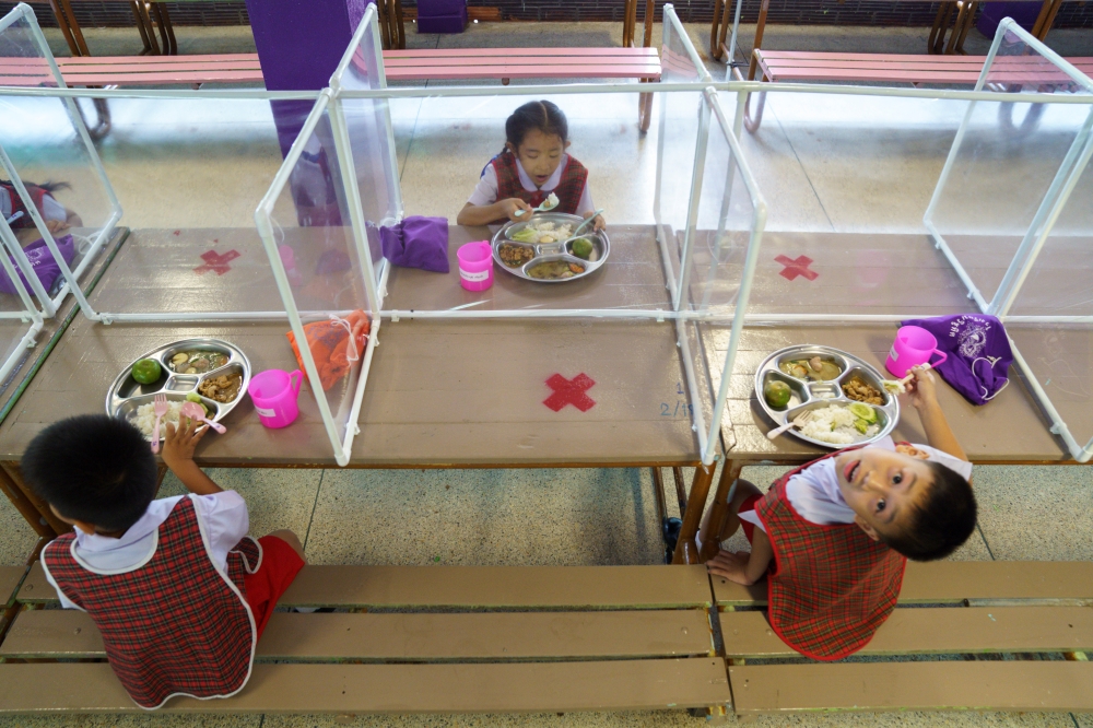 Kindergarten students from the Wichuthit school eat their lunch during a rehearsal social distancing and measures to prevent the spread of the coronavirus disease (COVID-19) ahead of nationwide schools reopening in Bangkok, Thailand, June 23, 2020. REUTER