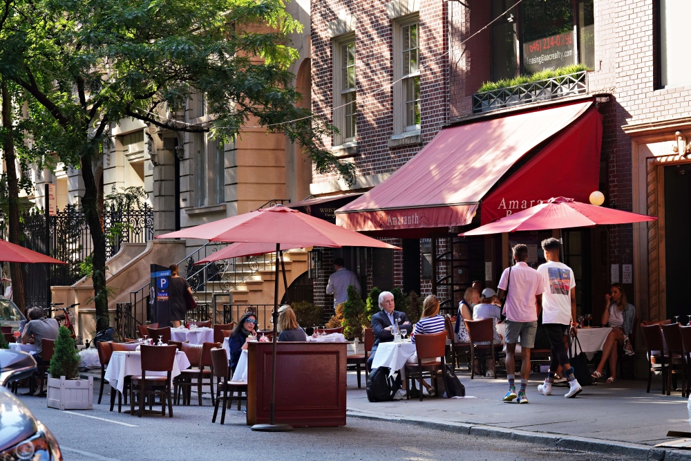 Customers at Amaranth are served at outside tables as the city moves into Phase 2 of re-opening following restrictions imposed to curb the coronavirus pandemic on June 23, 2020 in New York City. Cindy Ord/Getty Images/AFP
