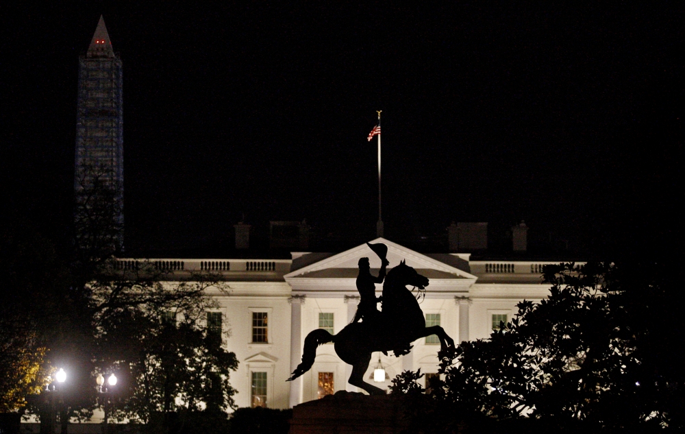 FILE PHOTO: The statue of U.S. President Andrew Jackson on his horse in the center of Lafayette Park is silhouetted against the White House in front of the Washington Monument (L) in Washington November 17, 2013. REUTERS/Jim Bourg/File Photo
