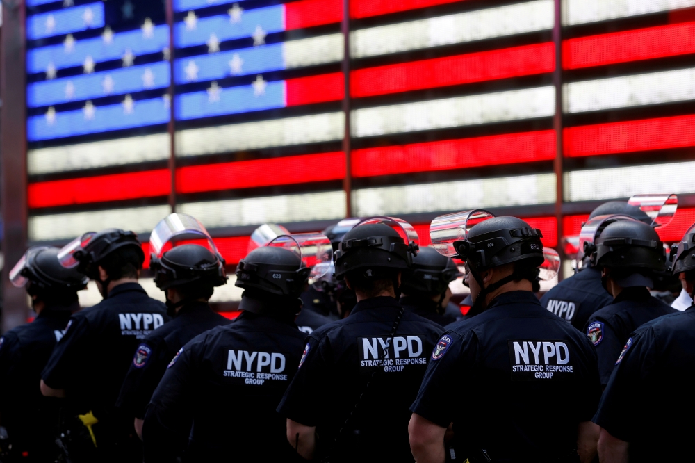 FILE PHOTO: New York Police Department (NYPD) officers are pictured as protesters rally against the death in Minneapolis police custody of George Floyd, in Times Square in the Manhattan borough of New York City, U.S., June 1, 2020. REUTERS/Mike Segar/File