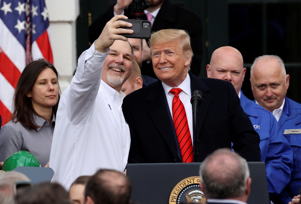 U.S. President Donald Trump poses for a selfie during a signing ceremony for the United States-Mexico-Canada Trade Agreement (USMCA) on the South Lawn of the White House in Washington, U.S., January 29, 2020. REUTERS/Jonathan Ernst/File Photo