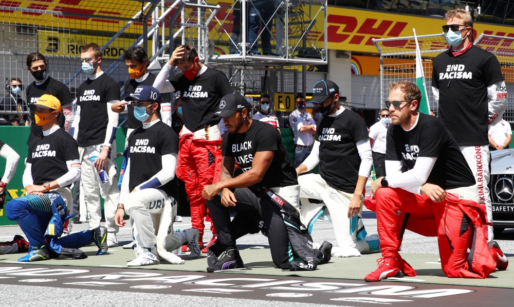 Formula One F1 - Austrian Grand Prix - Red Bull Ring, Spielberg, Styria, Austria - July 5, 2020 Mercedes' Lewis Hamilton, Ferrari's Sebastian Vettel and the rest of the drivers kneel on the grid wearing an anti-racism T-shirt before the race Mark Thompson