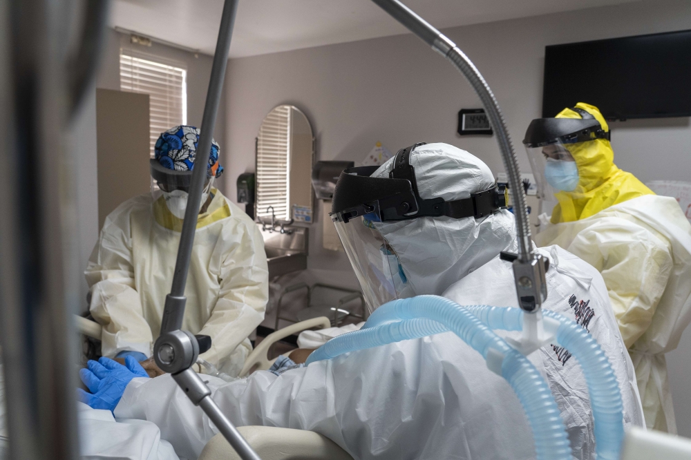 HOUSTON, TX - JULY 2: Members of the medical staff treat a patient in the COVID-19 intensive care unit at the United Memorial Medical Center on July 2, 2020 in Houston, Texas. COVID-19 cases and hospitalizations have spiked since Texas reopened, pushing i