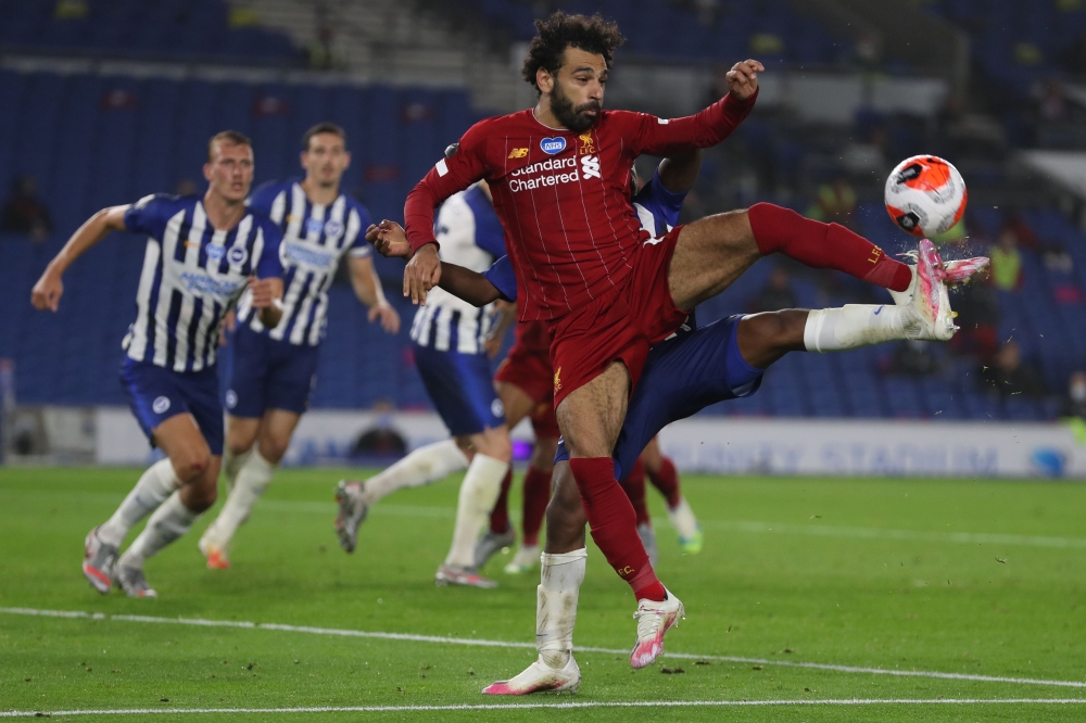 Liverpool's Egyptian midfielder Mohamed Salah controls the ball during the English Premier League football match between Brighton and Hove Albion and Liverpool at the American Express Community Stadium in Brighton, southern England on July 8, 2020. AFP / 