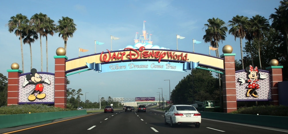 Visitors drive past a sign welcoming them to Walt Disney World on the first day of reopening of the iconic Magic Kingdom theme park in Orlando, Florida, on July 11, 2020.AFP / Gregg Newton / Gregg Newton
