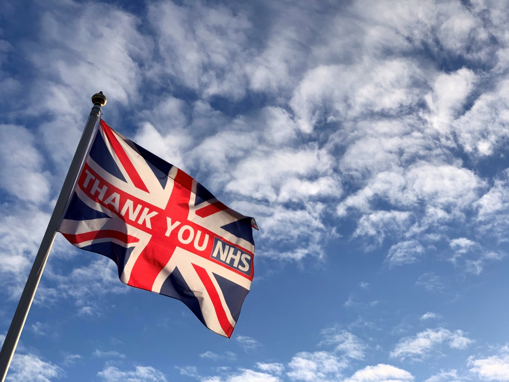 A British national flag, known as the Union Jack, with the words 'THANK YOU NHS' (National Health Service) is caught in an early morning breeze in London, Britain, July 6 2020. REUTERS/Russell Boyce/File Photo