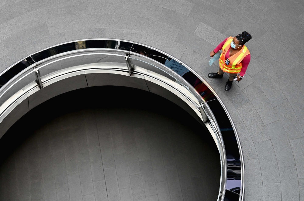 In this file photo an MTA worker walks through a nearly empty Fulton Street subway station complex on July 7, 2020 in Lower Manhattan, New York City. American families were slightly less pessimistic about their finances and jobs in June, but remained conc