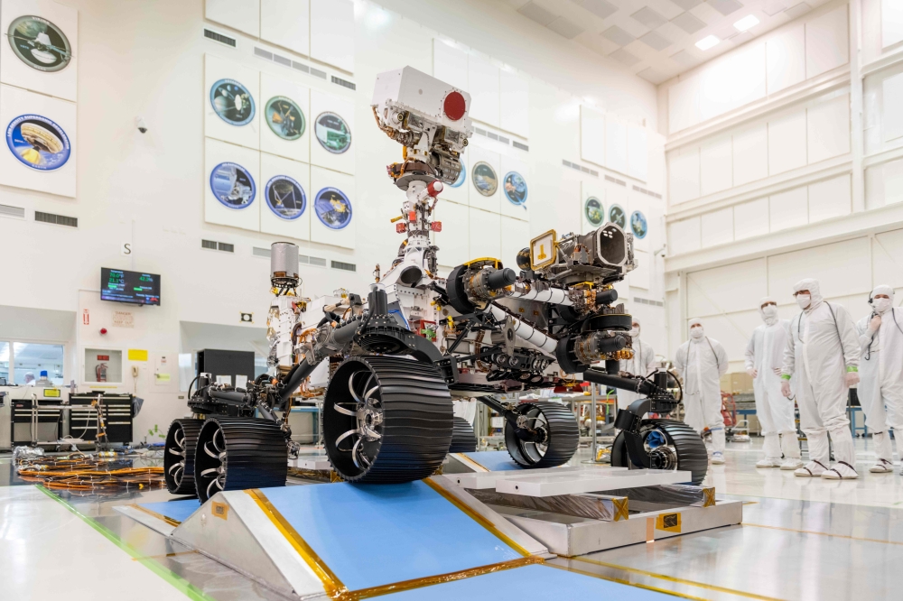 In this image obtained from NASA, engineers in a clean room at NASA's Jet Propulsion Laboratory in Pasadena, California, observe the first driving test for NASA's Perseverance rover on December 17, 2019. NASA's most advanced Mars rover, Perseverance, laun