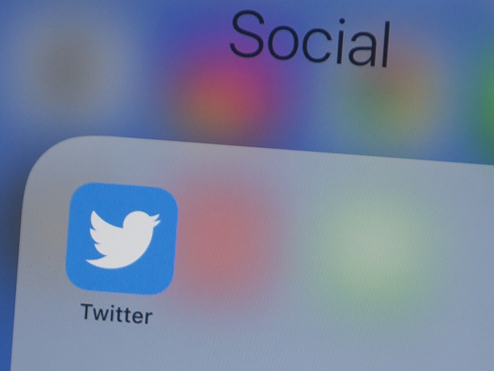 In this file photo taken on July 10, 2019, the Twitter logo is seen on a phone in this photo illustration in Washington, DC. The official Twitter accounts of Apple, Elon Musk, Jeff Bezos and others were hijacked on Wednesday by scammers trying to dupe peo