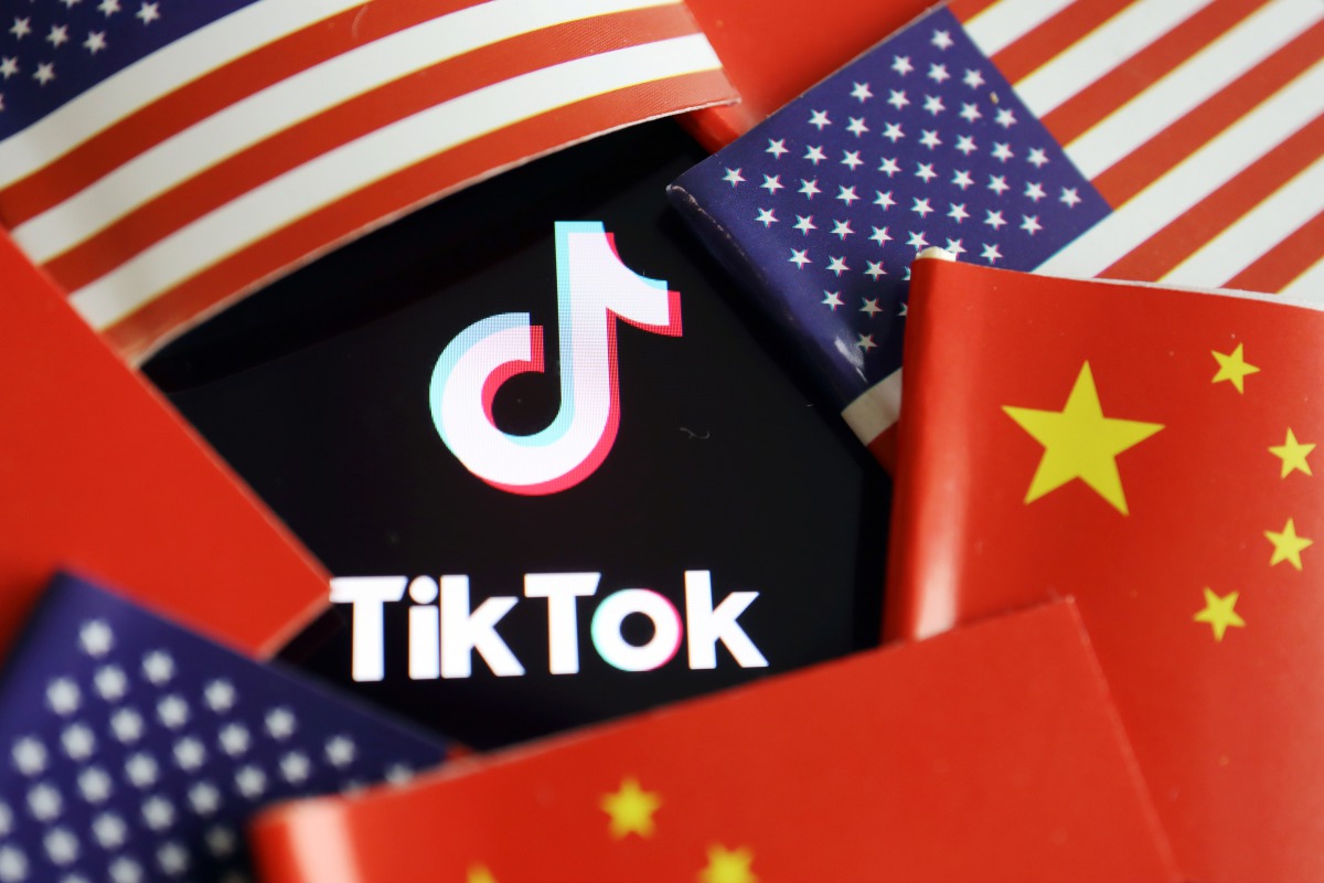 China and U.S. flags are seen near a TIKTOK logo in this illustration picture taken July 16, 2020. REUTERS/Florence Lo/Illustration
