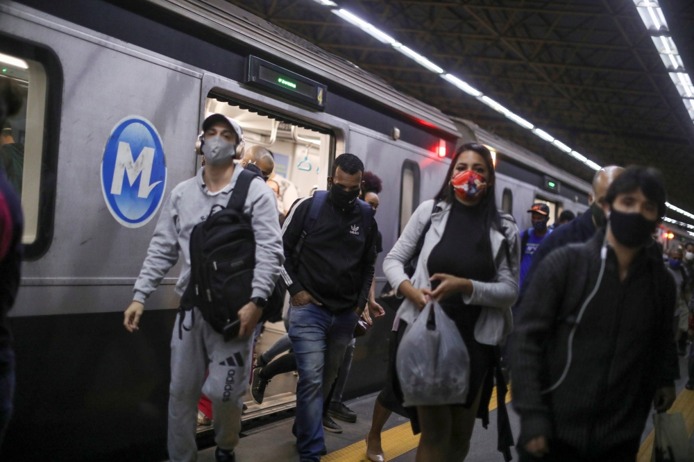 Commuters walk as they arrive at a metro station, amid the coronavirus disease (COVID-19) outbreak, in Rio de Janeiro, Brazil July 15, 2020. Picture taken July 15. REUTERS/Pilar Olivares
