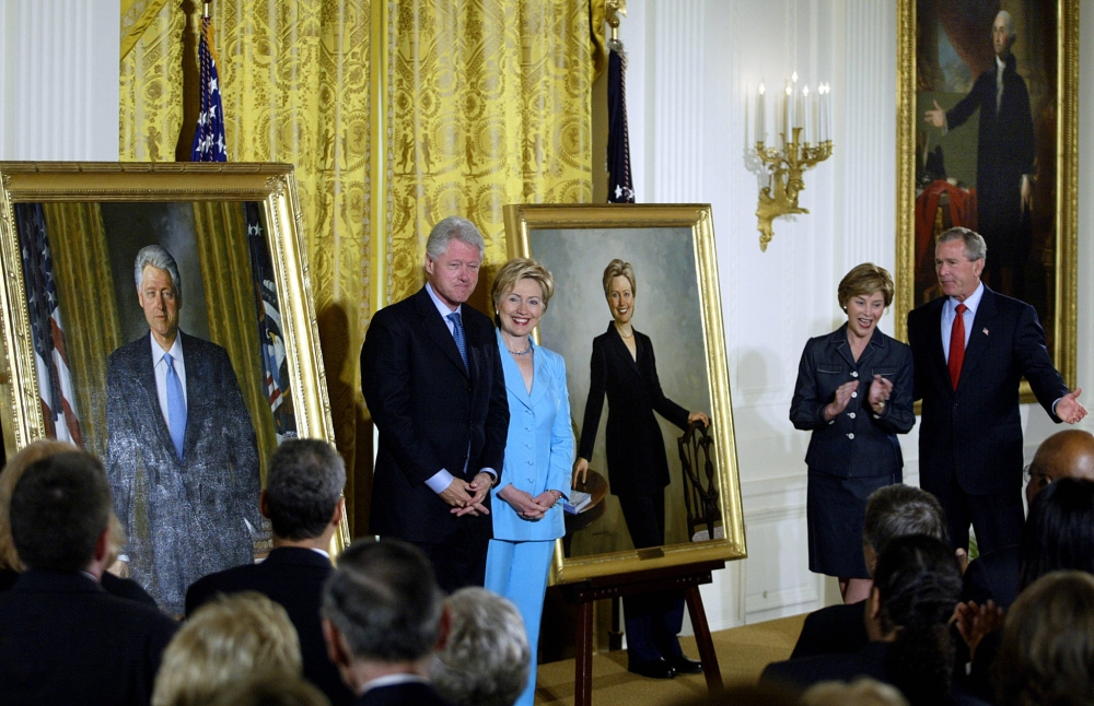 (FILES) In this file photo taken on June 14, 2004 Former US President Bill Clinton (L) and Senator Hillary Clinton (2nd-L) stand by their official White House portraits during the unveiling event hosted by President George W. Bush (R) and First Lady Laura