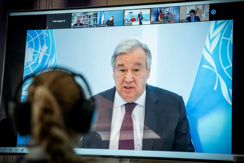 United Nations Secretary-General Antonio Guterres is seen on a video screen during a virtual climate summit, known as the Petersberg Climate Dialogue, in Berlin on April 28, 2020. Michael Kappeler/Pool via REUTERS/File Photo