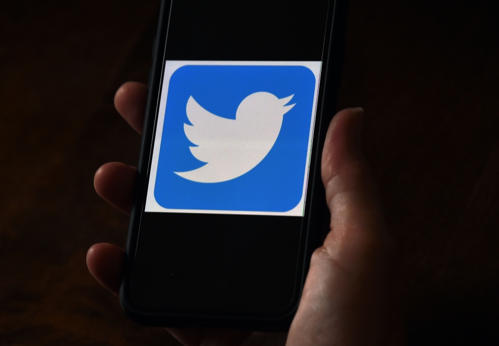 (FILES) In this file photo illustration, a Twitter logo is displayed on a mobile phone on May 27, 2020, in Arlington, Virginia. AFP / Olivier DOULIERY