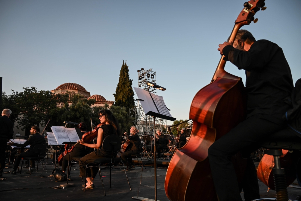 Members of the orchestra of the Greek National Opera prepares for a concert at the ancient Roman Agora in Athens on July 18, 2020. / AFP / Aris MESSINIS