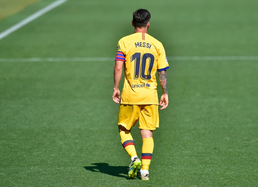 Messi walks on the pitch during the Spanish league football match between Deportivo Alaves and FC Barcelona at the Mendizorroza stadium in Vitoria on July 19, 2020. / AFP / ANDER GILLENEA
