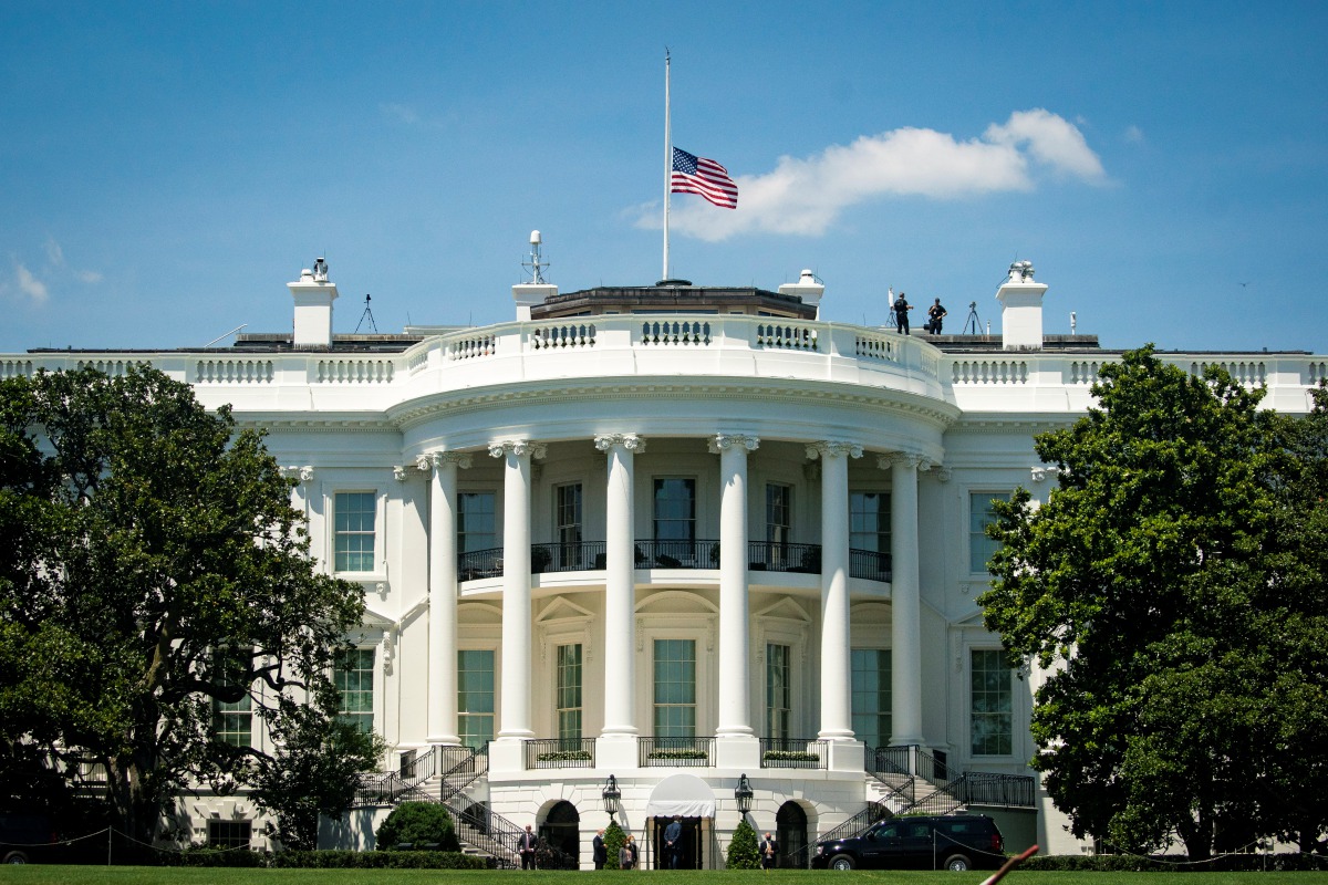 The American flag is lowered to half-staff following the death of Congressman John Lewis (D-GA), as U.S. President Donald Trump arrives after playing golf at his club in Sterling, Virginia, at the White House in Washington, U.S., July 18, 2020. REUTERS/Al