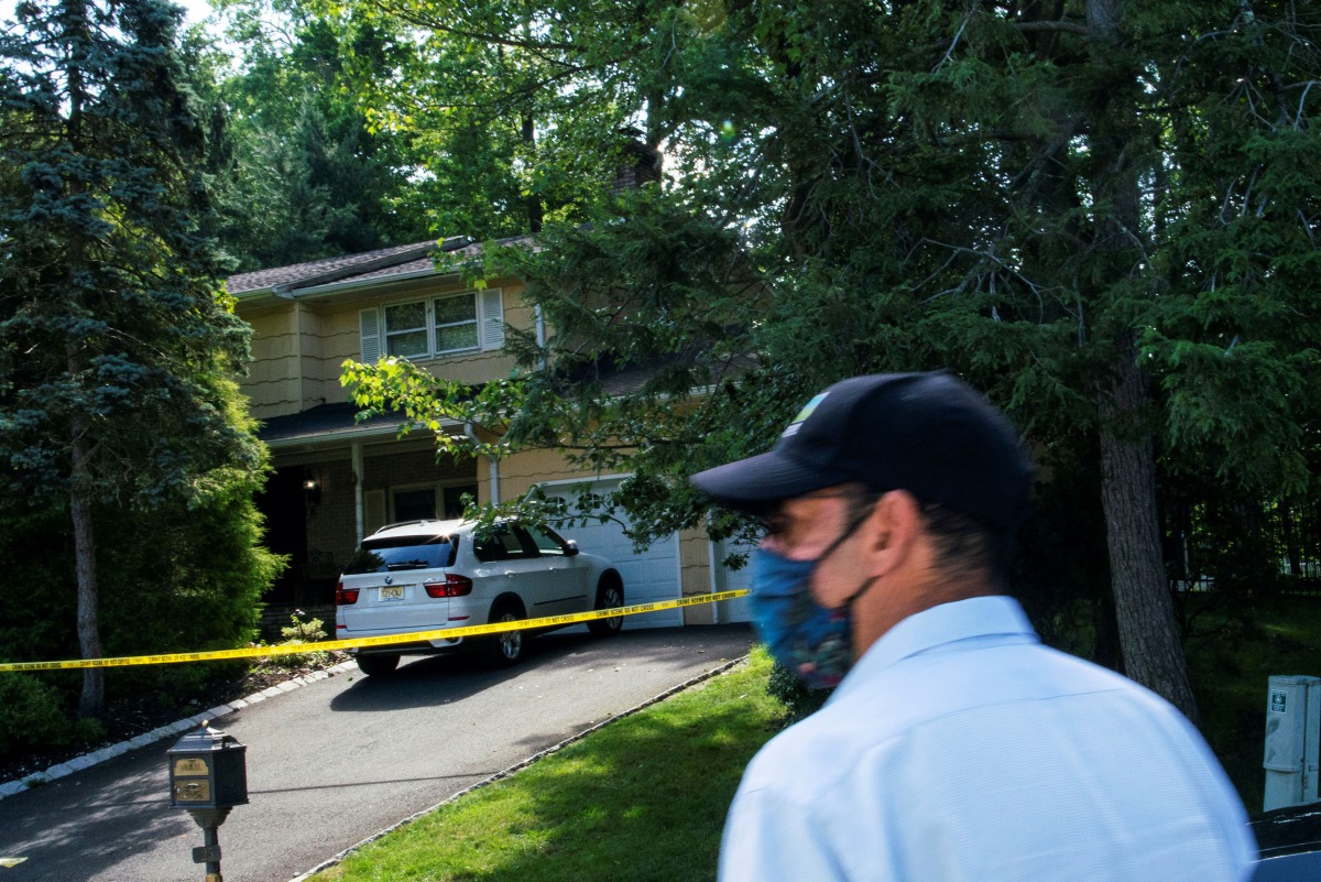 A man walks outside the home of federal judge Esther Salas, where her son was shot and killed and her defense attorney husband was critically injured, in North Brunswick, New Jersey, U.S. July 20, 2020. REUTERS/Eduardo Munoz
