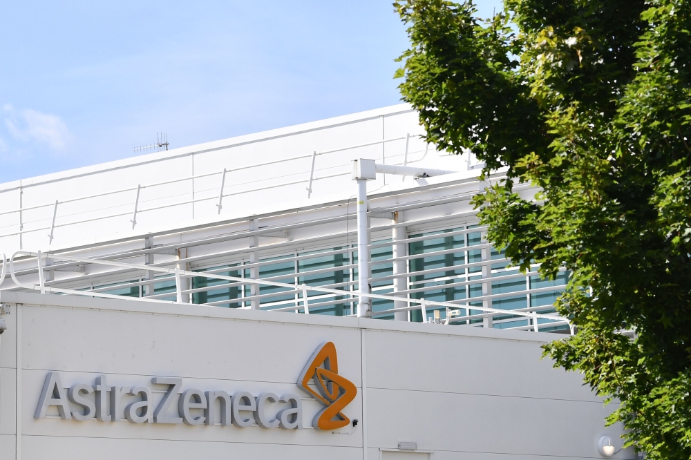 A sign is pictured outside the AstraZeneca factory in Liverpool north west England on July 20, 2020. Britain's government has already said it would purchase 100 million doses of a vaccine currently being trialed by Oxford University in partnership with As